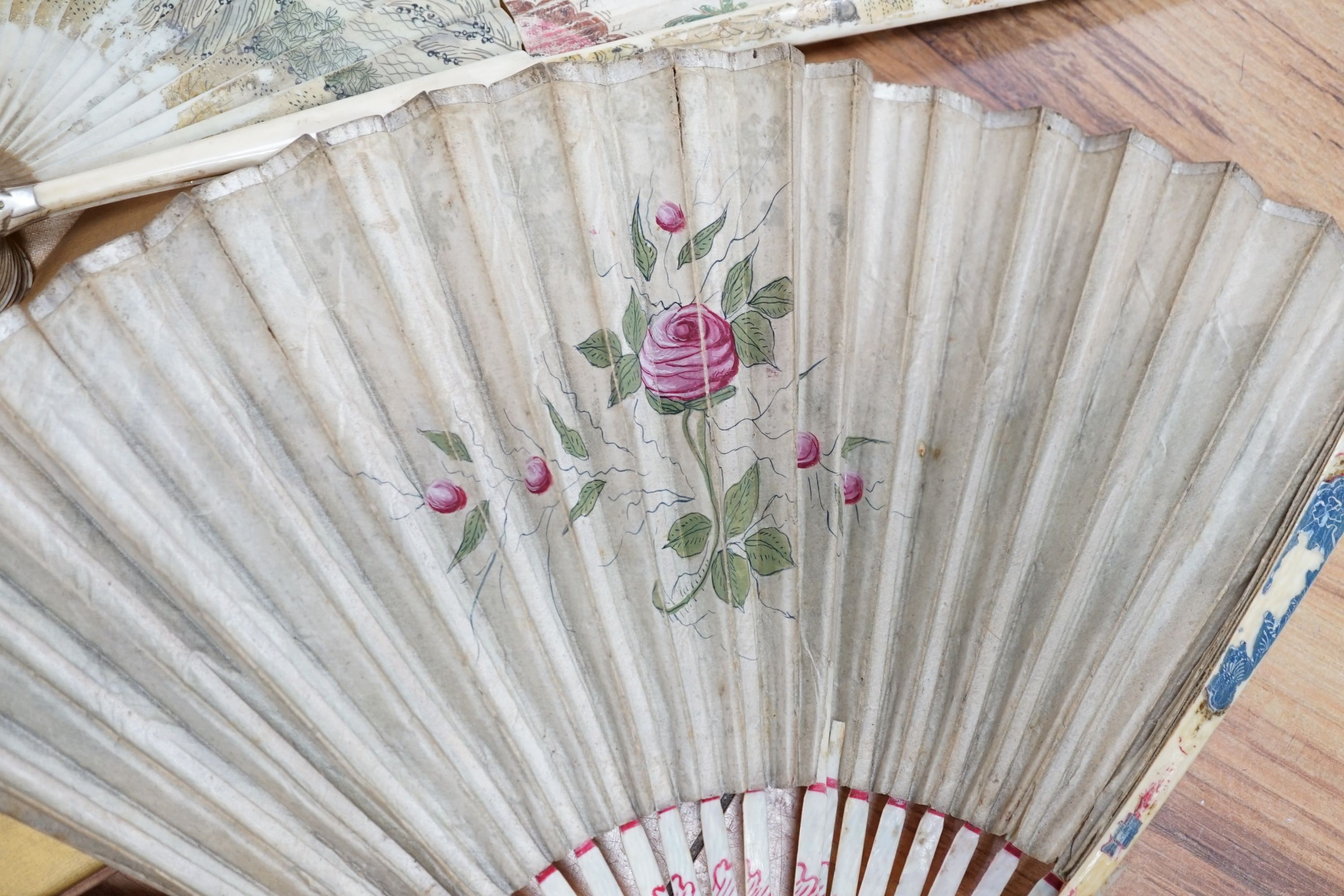 Five various fans, and an 18th century painted leaf fan with ivory chinoiserie decorated guards and sticks, 28 cms high (6)